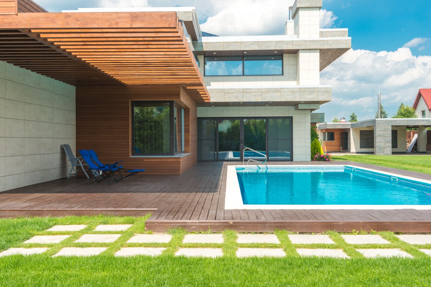 Contemporary villa with pale stone, a warm timber pergola and pool